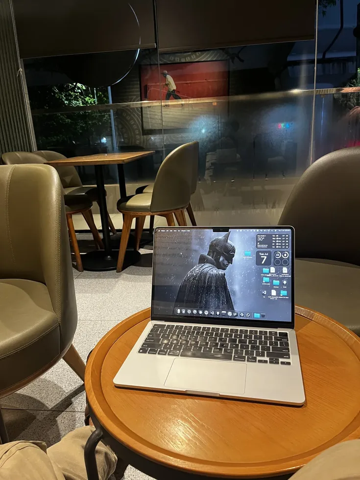 Laptop open at a Starbucks table at night